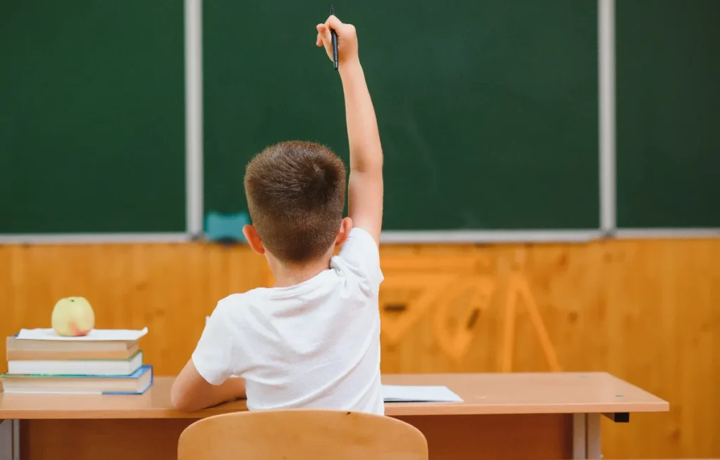 ADHD school support strategies, Child raising hand in class