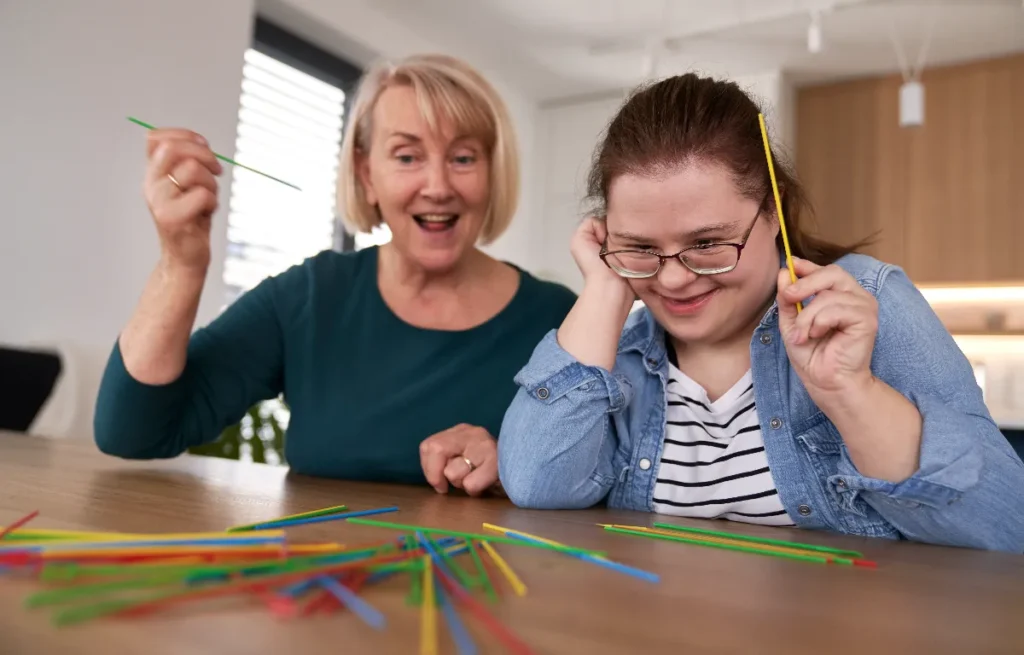 What is a learning disability? Mother playing with child with down syndrome